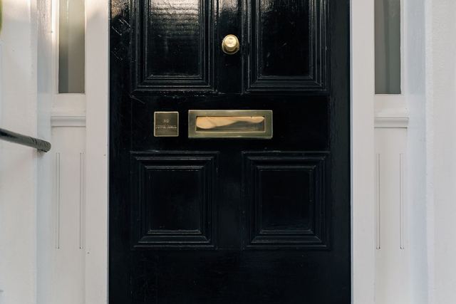 A black London front door with brass fittings