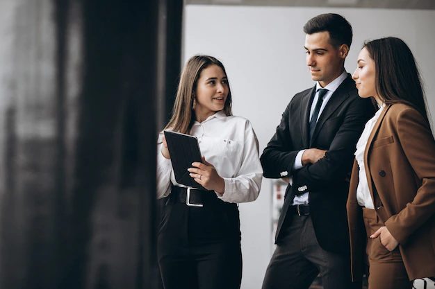 Three colleagues planning a new business on a tablet